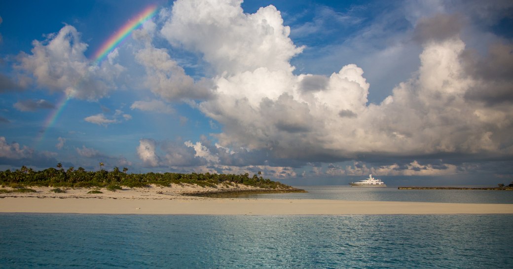 Superyacht DREAM below a rainbow, chartering in the South Pacific 