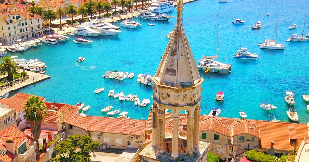 Elevated view looking down over the rooftops of Hvar and the marina