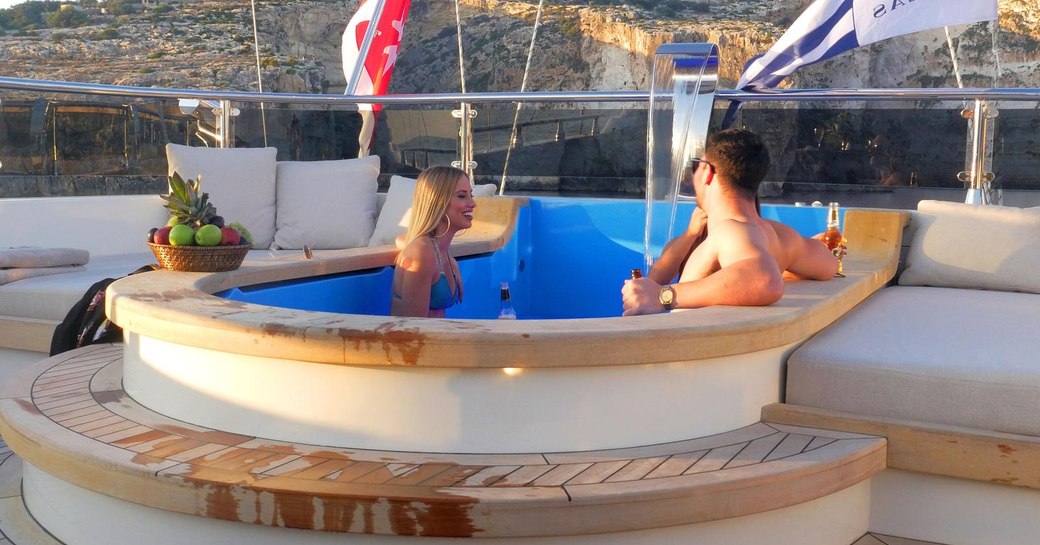 Two people relaxing in spa pool on luxury sailing yacht ARESTEAS