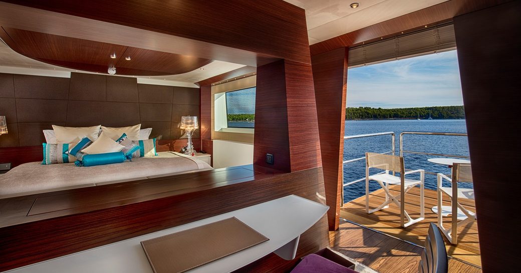 Charter yacht KATINA guest cabin with large berth and a fold-down balcony