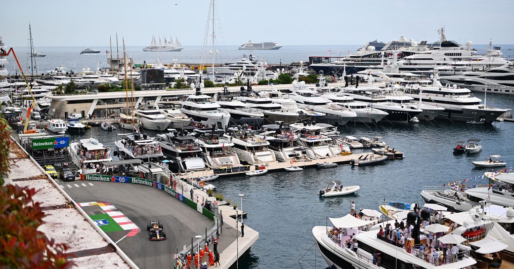 Port Hercule with motor yacht charters and Formula One car on track