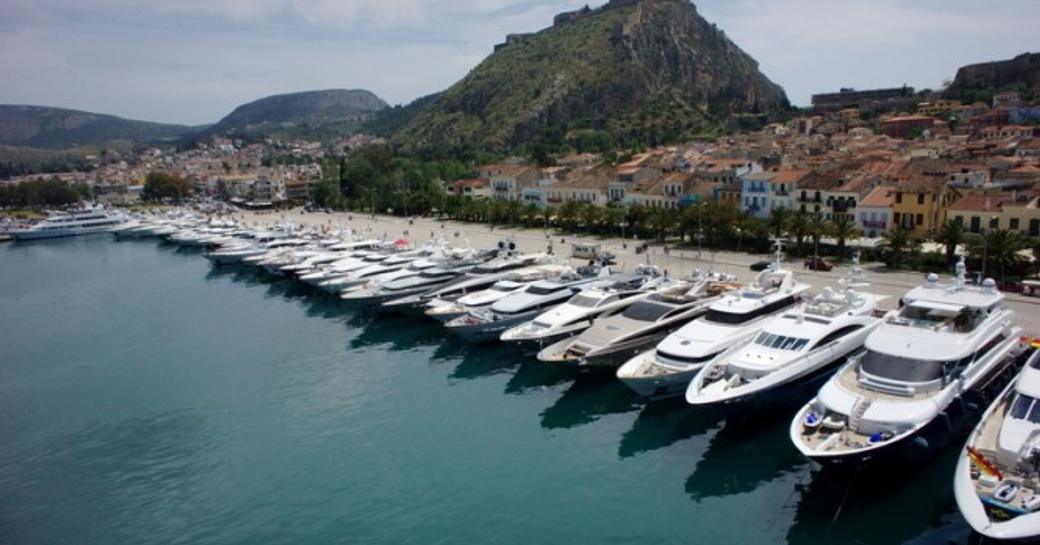 charter yachts moored in line at the Mediterranean Yacht Show.