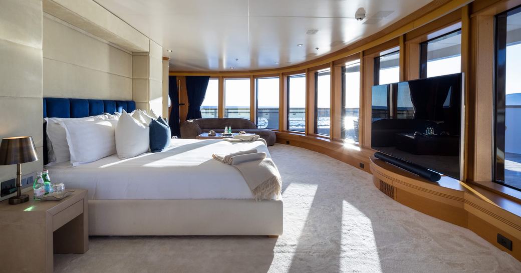 Master cabin with central berth and panoramic windows onboard charter yacht BOADICEA