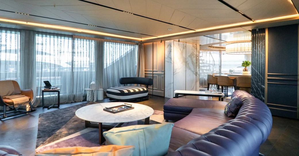 Main salon with purple sofas onboard charter yacht RAJA²