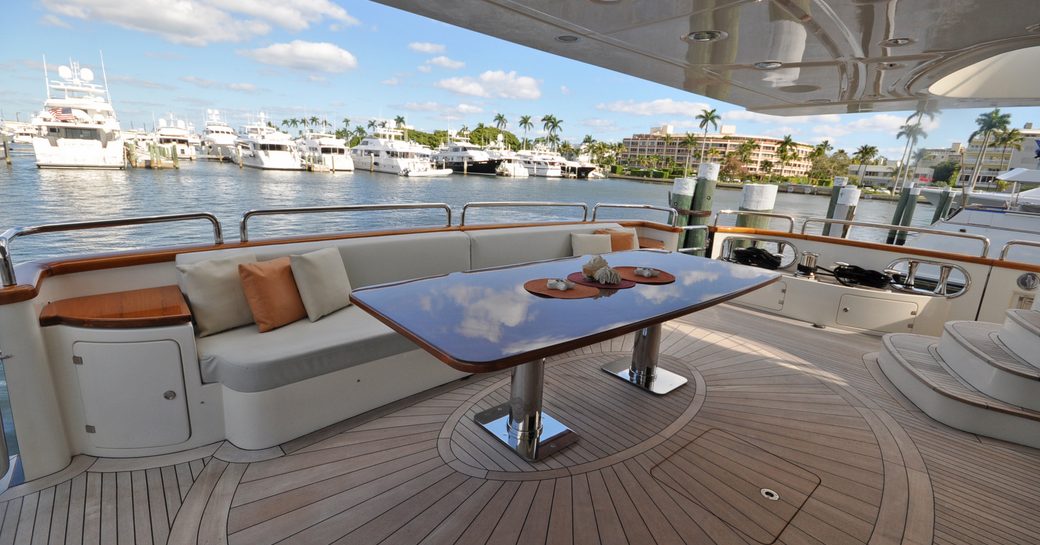 Alfresco dining option onboard boat charter VIVERE, cream seating with a dining table