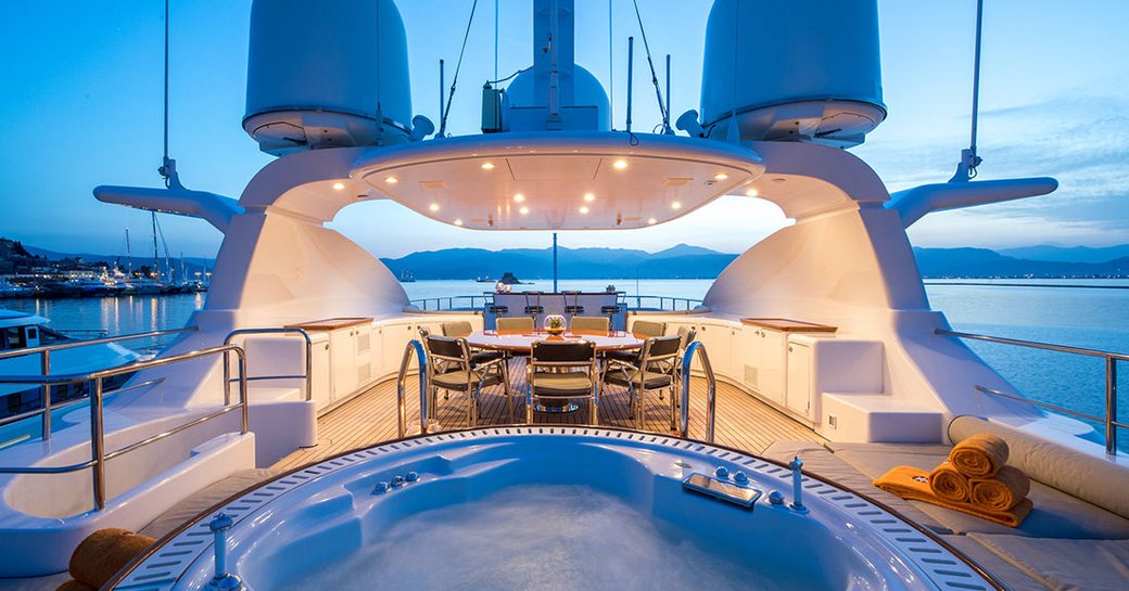 sundeck of superyacht magenta m, with spa pool and dining area