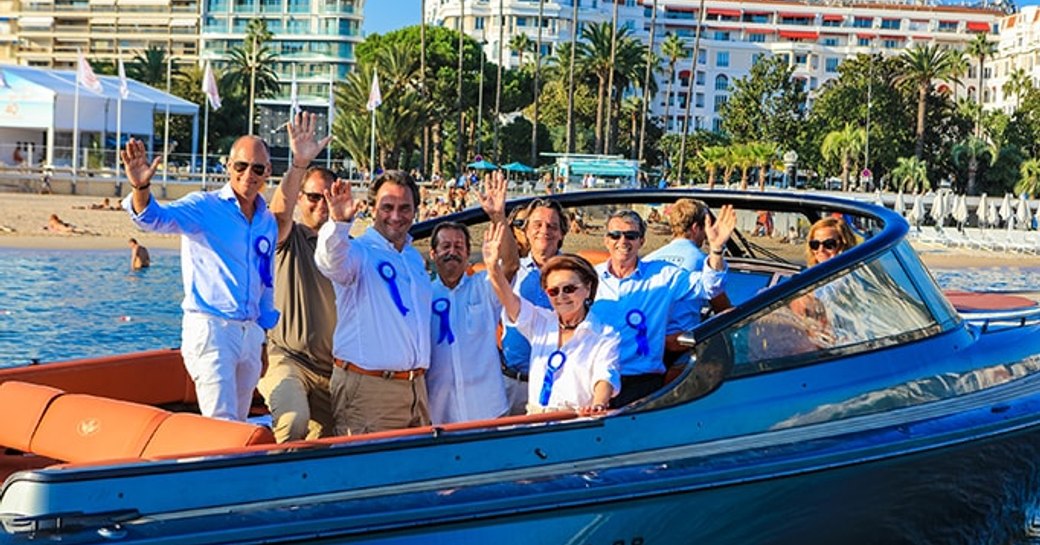 crew of prize winner on board day-boat as part of Concours d’Elegance parade