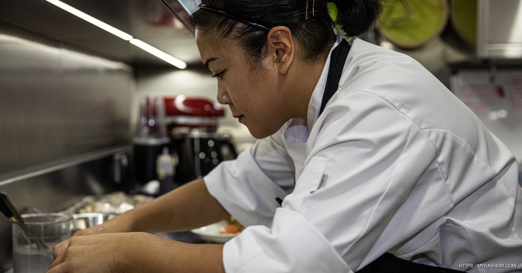 A superyacht chef busy in a kitchen