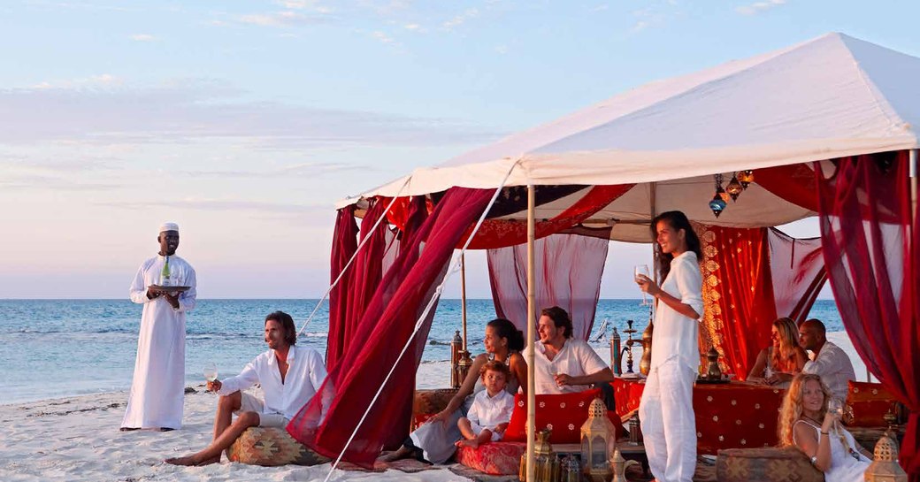 people dining in tent on the beach on thanda island