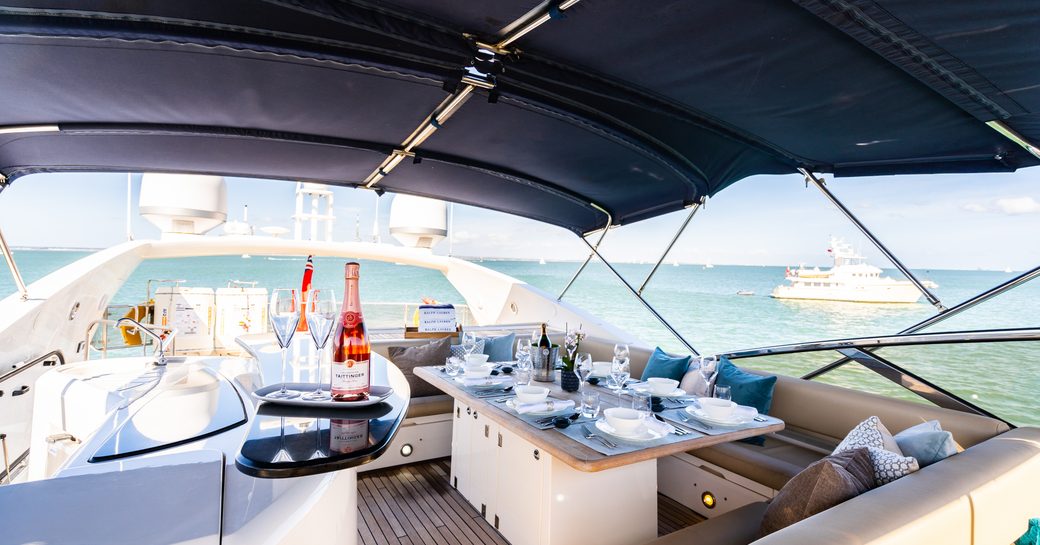 sundeck on luxury yacht chess, with champagne on table