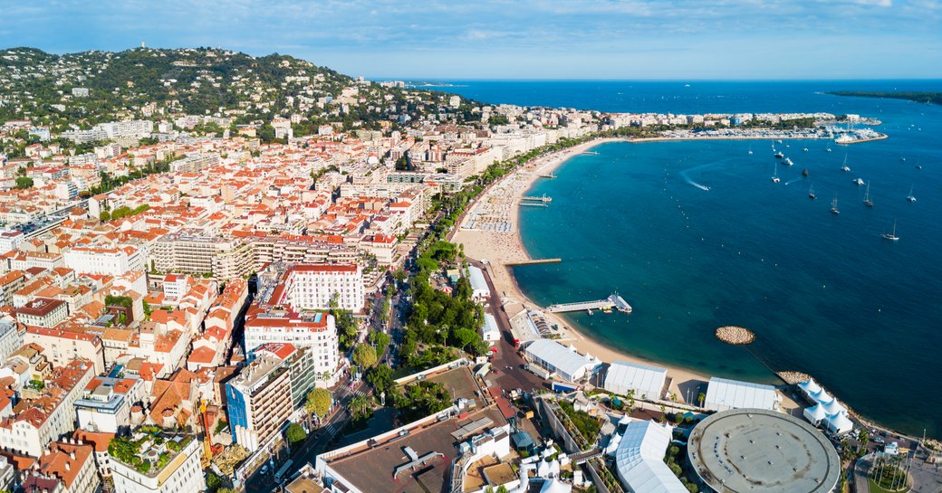 Aerial view of Cannes. Settlement to port side with view of Bay of Cannes to starboard.