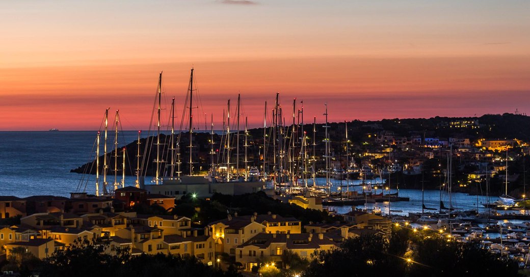 yachts gather in Porto Cervo marina as the sun sets during the Perini Navi Cup