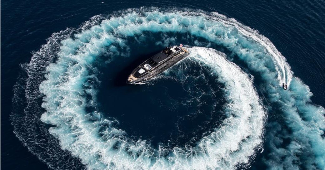 Motor yacht ABILITY with a circling tender