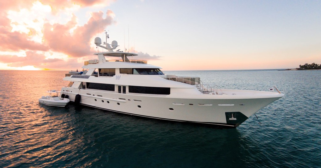 Superyacht W at anchor with sunset in background