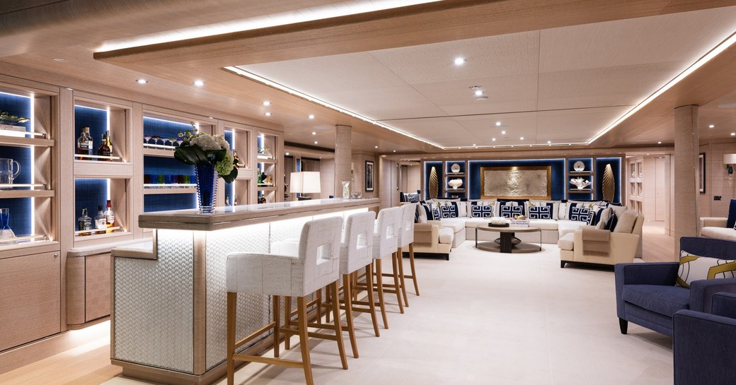 Overview of the main salon onboard charter yacht STARBURST IV, with a wet bar forward and a lounge area aft.