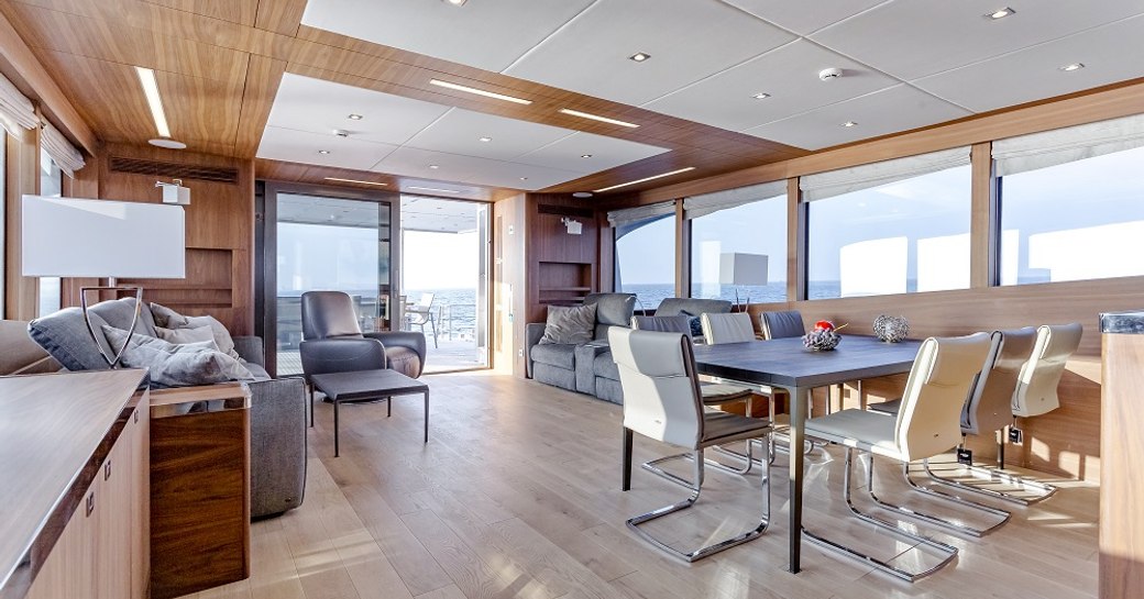 dining table and lounge area aft in the main salon of superyacht Timeless 