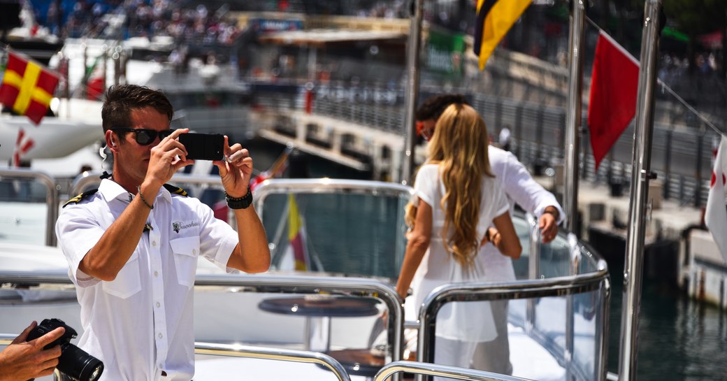 Man takes picture of the racecars on the track at the Monaco Grand Prix 2019