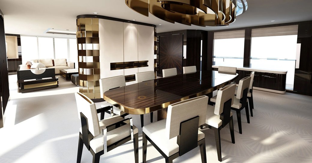 main salon of charter yacht soaring, with dining and gold light fixture