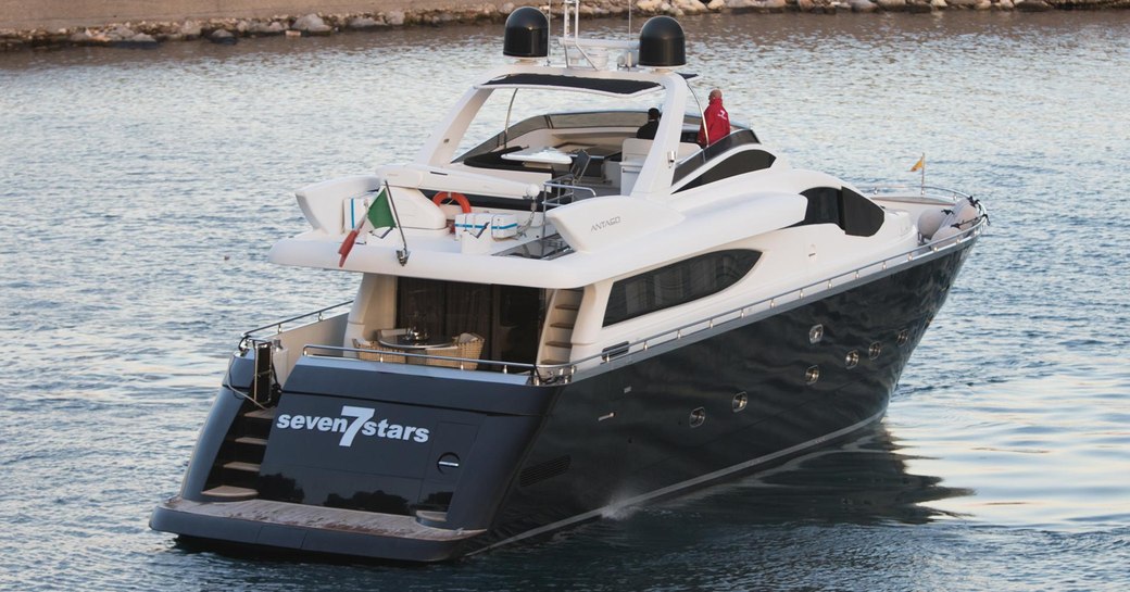 Aft view of charter yacht SEVEN STARS underway in a marina