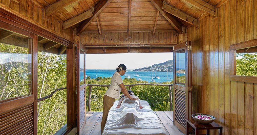 woman massaging at treetop spa 