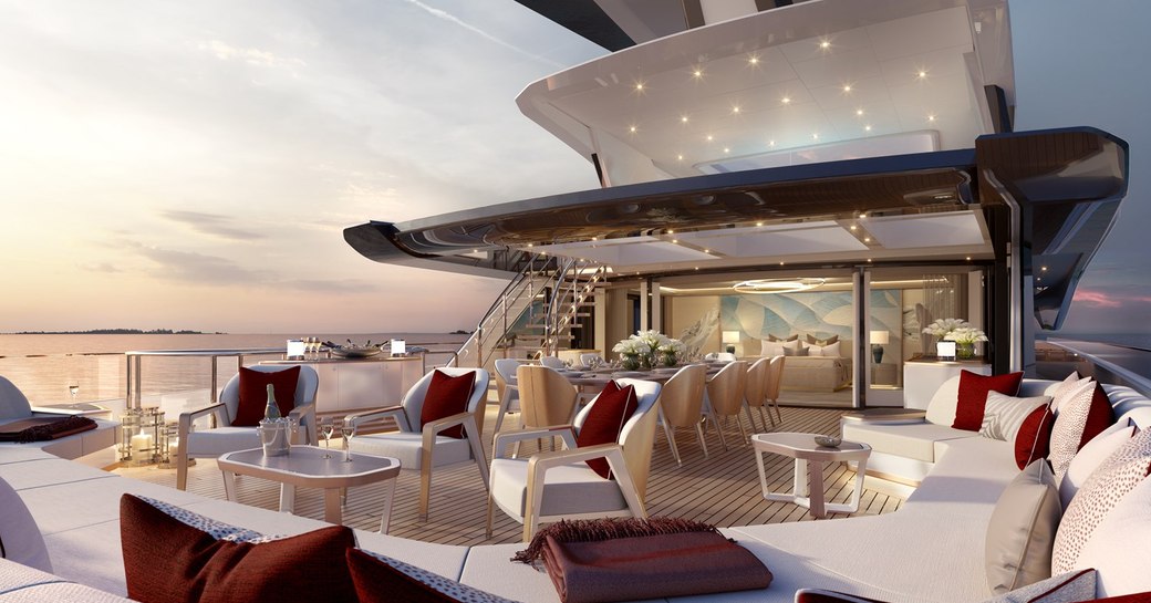 Exterior lounge area onboard superyacht SPARTA, multiple seating arrangements with red cushions.