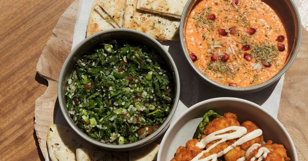 Three plates of food on brown table