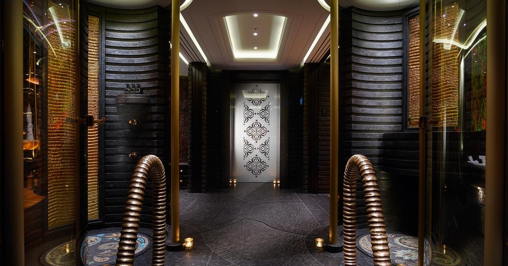 The black paneling and gold accents featured around the interior of superyacht KISMET