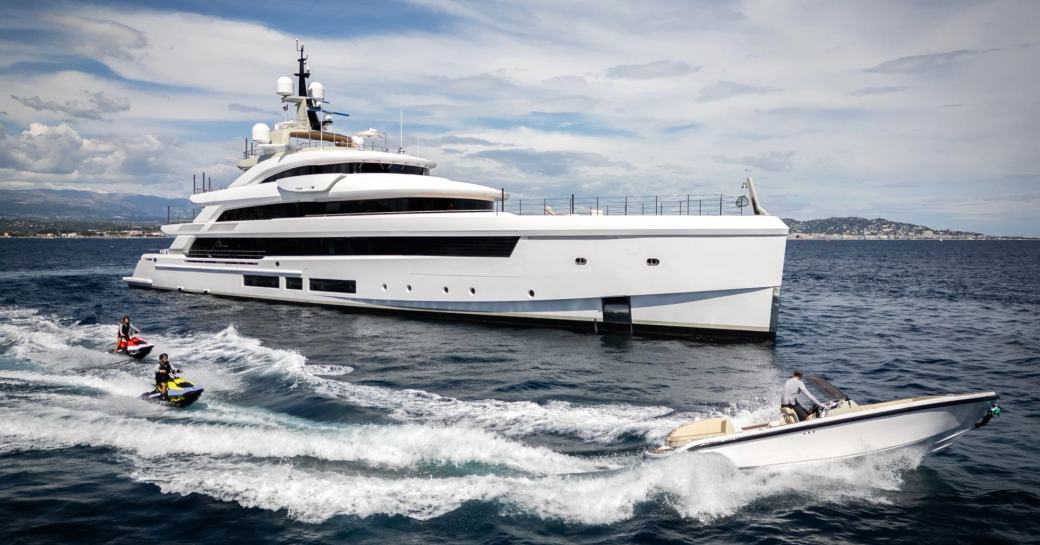 Charter yacht LADY A at sea with water toys in the foreground