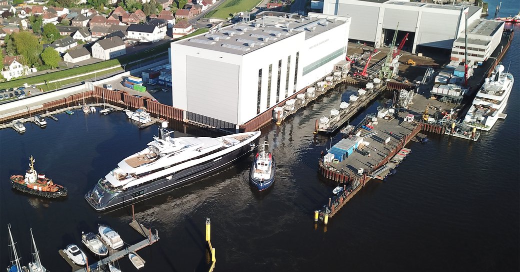 An aerial photo taken outside of the Abeking & Rasmussen shipyard showing superyacht ELANDESS