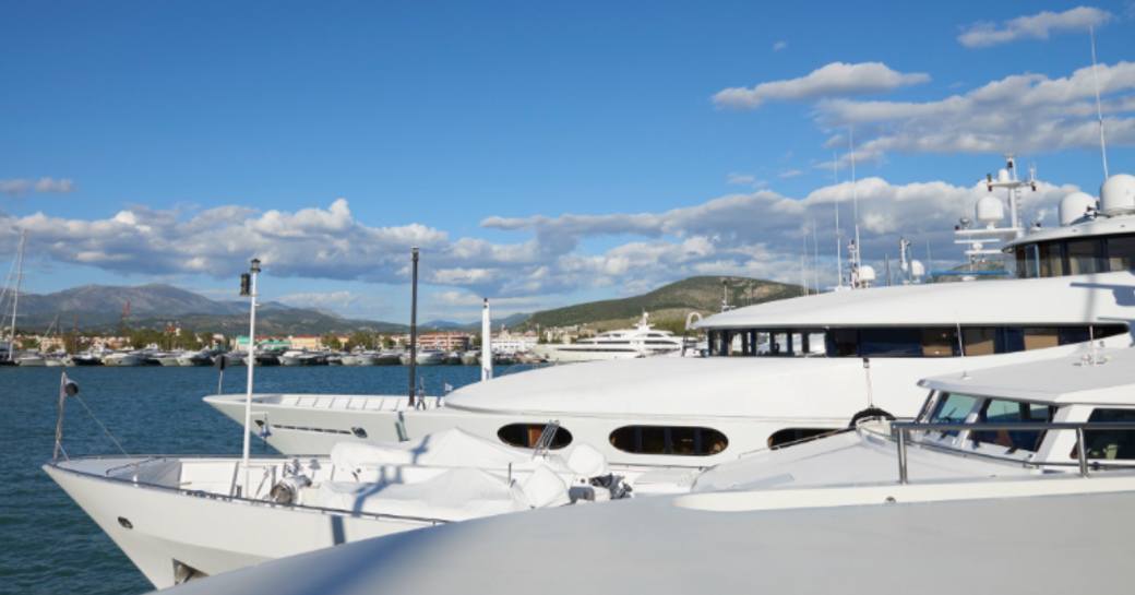 Line of charter yachts berthed at Mediterranean Yacht Show.