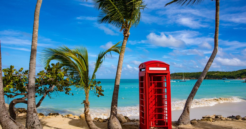 Red phone box on a beach in the British Virgin Islands