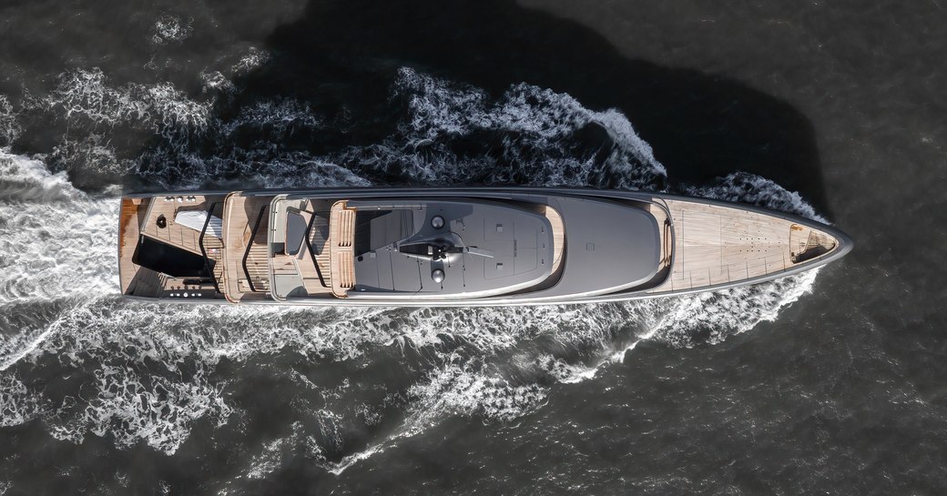 Aerial bird's eye view looking down on superyacht OBSIDIAN underway at sea.