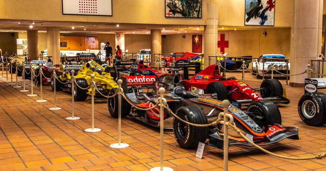 Racing cars inside the Collection de Voitures Anciennes in Monaco behind a rope barrier