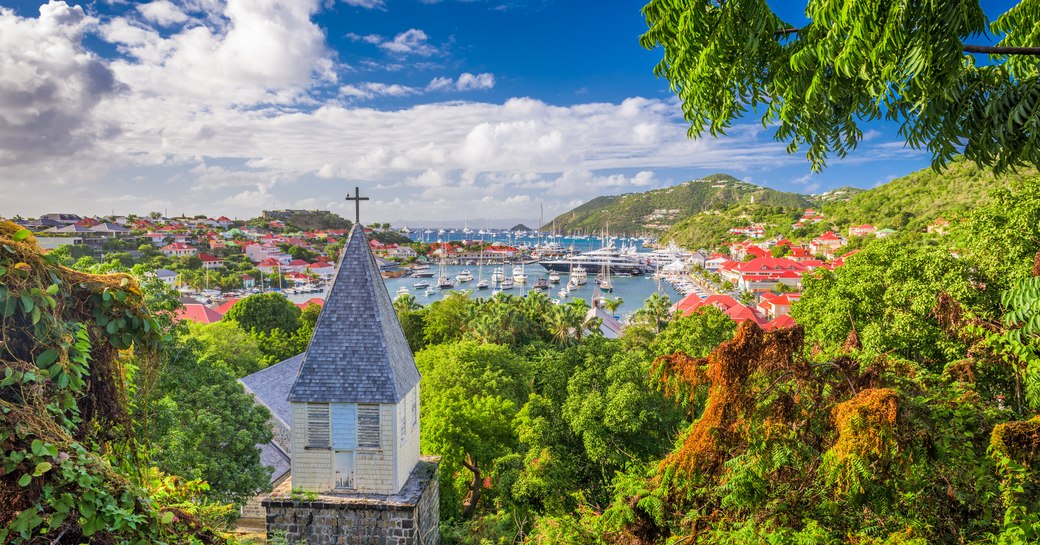 Gustavia Harbour in St Barts as seen from hilltop covered in greenery