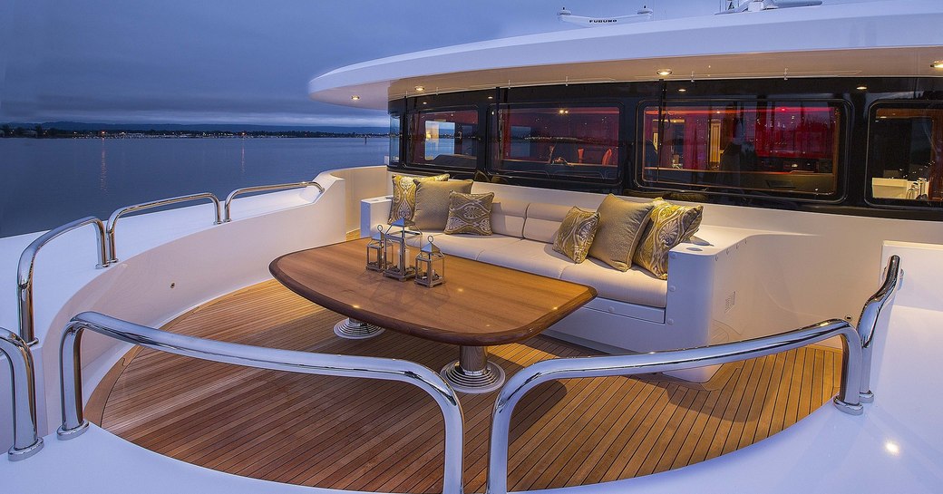 A table with sofa seating on the Portuguese Bridge of luxury yacht Silver Lining