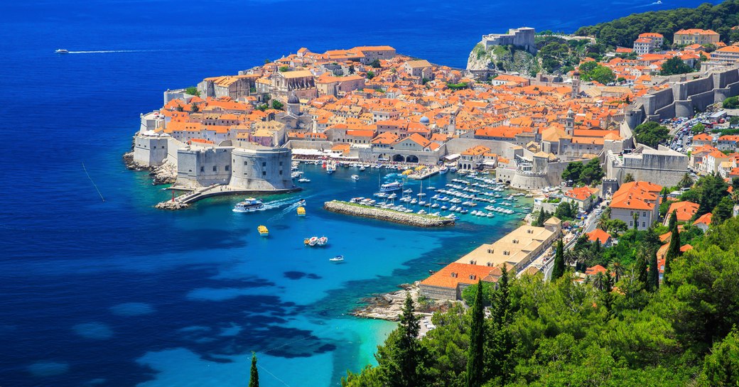 croatian city of dubrovnik with red roof buildings and ancient stone walls as seen from aerial perspective
