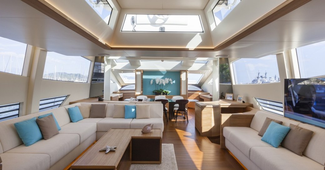 Light filled interior with tables and comfortable sofas on superyacht 55 FIFTYFIVE