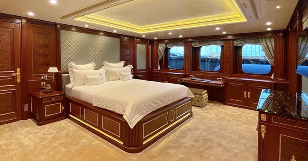 Master cabin onboard charter yacht BLACK PEARL with central berth and multiple windows aft.