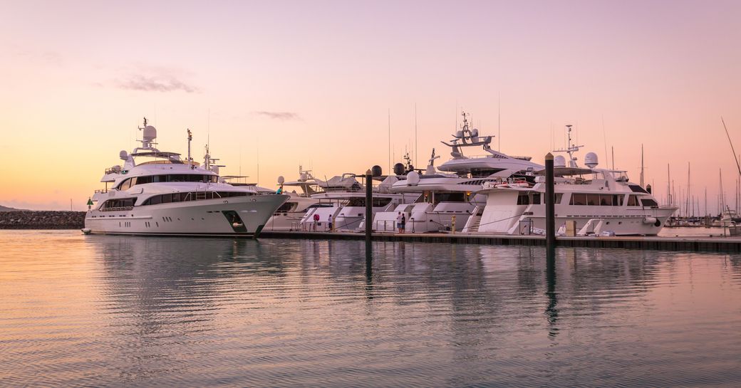 Sunset over superyachts at Coral Sea Marina and Resort