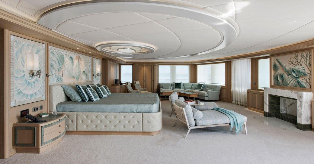 Master cabin onboard charter yacht DREAM, central berth facing forward with a seating area adjacent