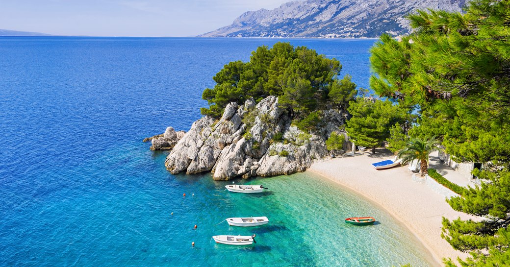 Sandy beach on island in Croatia, with clear, lagoon blue water