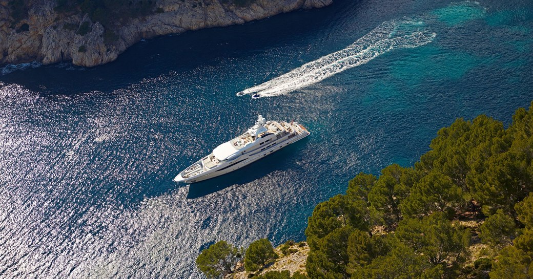 aerial image of superyacht spirit at anchor in small bay in greece