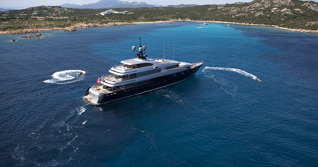 Superyacht SLIPSTREAM at-anchor with surrounding tenders