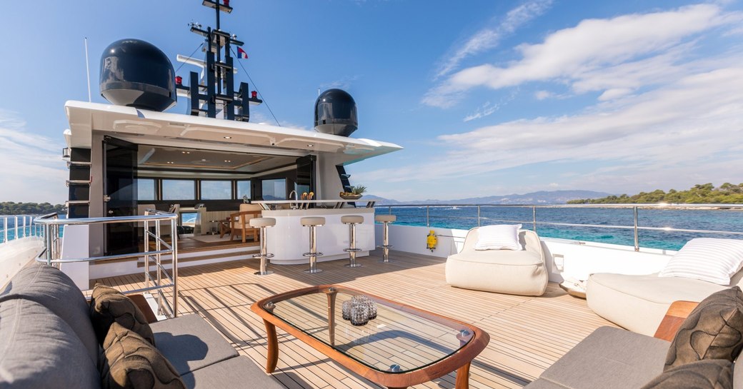 expansive flybridge with seating areas and bar on board superyacht ONEWORLD