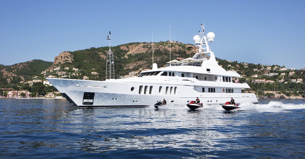 Superyacht 'Talisman Maiton' seen from the starboard side with jetskis beside it