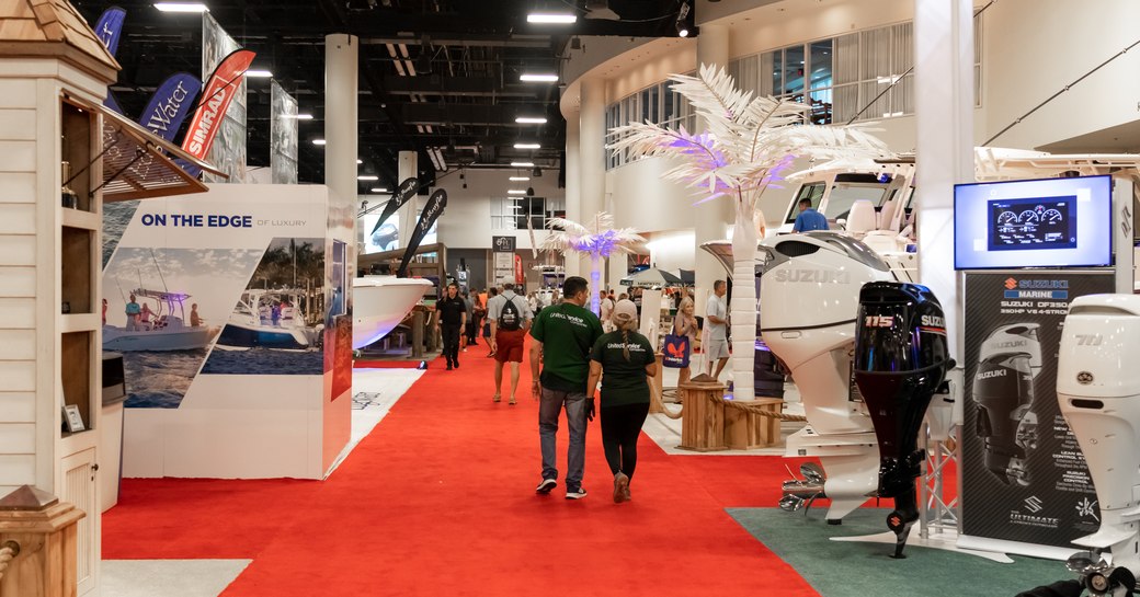 Broward County Convention Center during FLIBS. Visitors walking along red carpet between exhibitor stands.