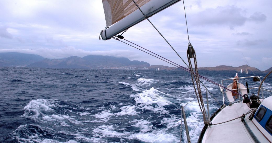 A sailing yacht charter underway taking part in the St Barts regatta