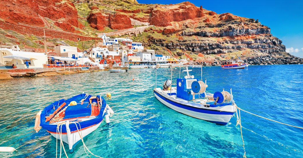 Boats docked in Santorini's blue waters