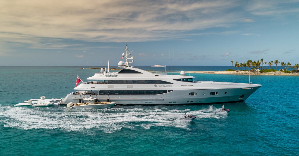 yacht in the open sea, with tenders alongside