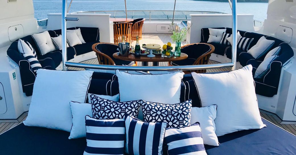 Exterior seating onboard charter yacht LADY AZUL with nautical themed cushions